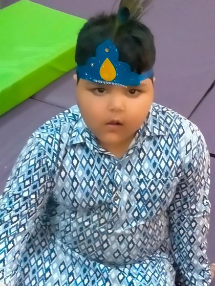 A young boy dressed in traditional attire for our Janmashtami workshop. We encourage kids to immerse themselves in the spirit of the festival.