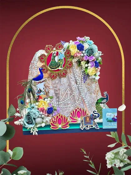 This Teej hamper is all about celebrating tradition. We created a stunning display for a beautiful saree, using peacock motifs, lotus cutouts, and colorful flowers to make it truly special.