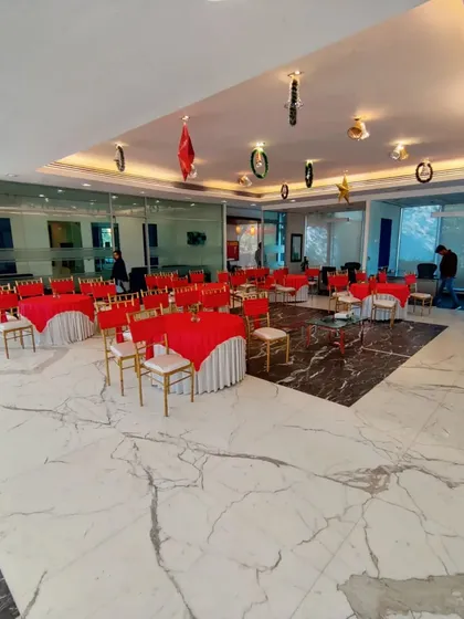 A wider perspective of the BPTP Amstoria sales office event. The layout shows the combination of round tables for dining and theater-style seating, offering flexibility for different activities within the same corporate event.