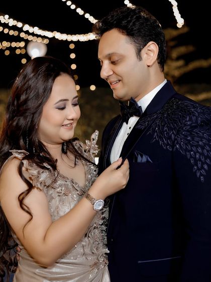 A lovely, candid moment where the bride adjusts the groom's suit. These small, unscripted gestures often make for the most heartfelt photos.