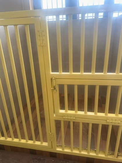 A close-up of our custom-made suites. The wooden flooring is comfortable for them to lie on, and the bars provide good ventilation while being completely secure.