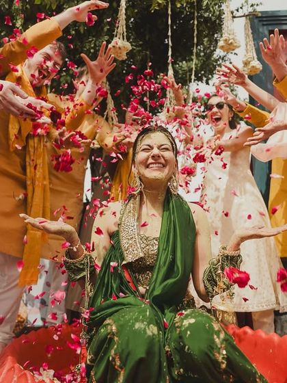 The bride's haldi had its own beautiful chaos. A flower shower from friends and family created this stunning, joyful moment of celebration.