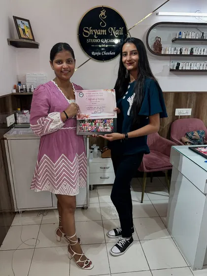 Presenting a certificate of completion to a talented student. Look at the variety of art she learned to create.