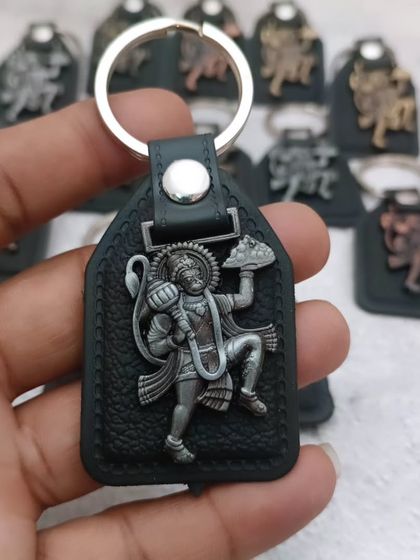 A close-up of the Hanuman keychain, showing the detailed depiction of the deity. A perfect, small token of faith.