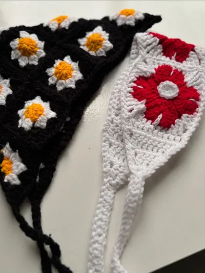 My crochet bandanas are a Pinterest dream. Here are two popular styles: a black one with white and yellow daisies, and a white one with a bold red flower design.