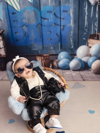 The ultimate boss pose. With her sunglasses on and a cool demeanor, this baby girl perfectly captures the essence of the 'Boss Baby' theme.