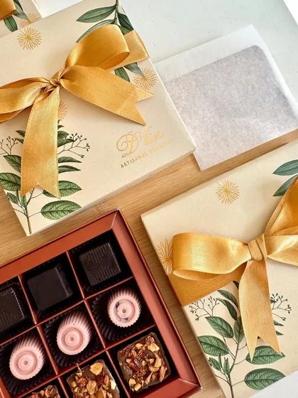 The art of gifting, perfected. This elegant box holds our artisanal chocolates, including rich coffee truffles, tangy cranberry chocolates, and crunchy almond praline truffles, all beautifully packaged for a memorable unboxing experience.