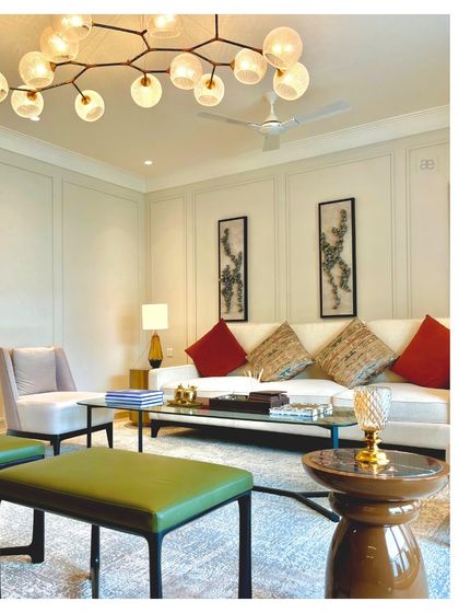 Another view of the DLF apartment living room, showing the carefully balanced composition of furniture and decor. The space is designed to feel both luxurious and comfortable.