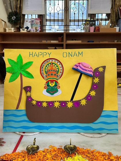 A child looks on at the colorful Onam art display, a visual introduction to the stories and symbols of the festival.