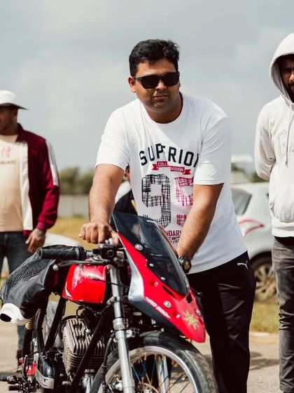 A participant with his custom red drag bike, ready to take on the strip. The pride and passion are evident.