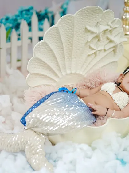 Another angle of the six-month mermaid shoot, capturing her sweet smile and the detailed setup.