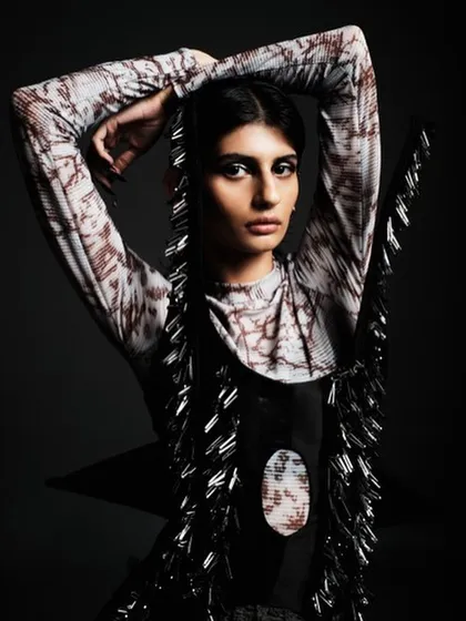 A powerful high-fashion look for a designer collection, featuring sharp, dark, winged eyeliner and a sleek, pulled-back hairstyle. The focus is on creating a strong, almost architectural facial structure.