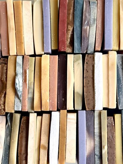 A beautiful flat lay of our colorful mini soap bars. Each one is a tiny version of our full-sized cold process soaps.