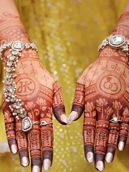 This engagement mehndi features the couple's initials and ring symbols. It's a beautiful way to celebrate your new beginning, with a design that is both personal and elegant.