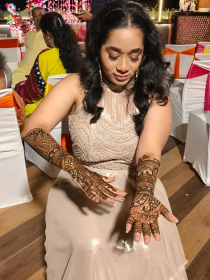 A moment of quiet admiration as the bride looks at her beautifully decorated hands.