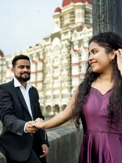 A candid, happy moment during a pre-wedding shoot at the Gateway of India in Mumbai.