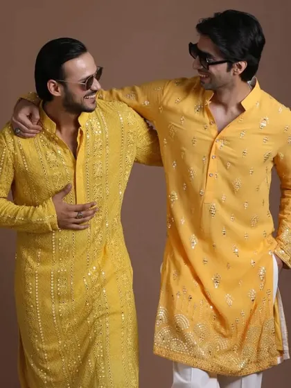 Brothers or friends can coordinate in style. This image shows two different yet complementary yellow kurtas, perfect for a unified look at a wedding event.