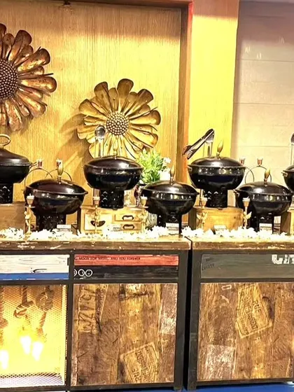 A full view of the dual rustic counters, showcasing a complete and cohesive buffet line. The setup is both functional and a key part of the event's aesthetic.