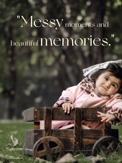 Messy moments and beautiful memories. A cozy toddler peeks out from a wooden wagon in the park.