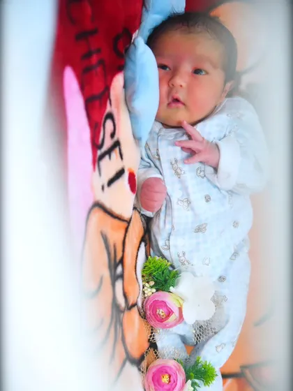 A sweet, candid shot of a baby looking up, captured with soft, natural-looking light.