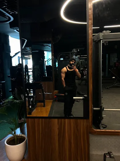 A mirror selfie showing the depth of our gym. The reflection reveals rows of equipment, ensuring you never have to wait to get your workout in.