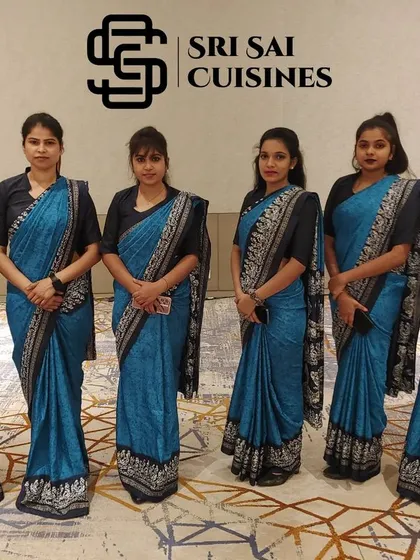 For traditional events like weddings and cultural celebrations, our staff can be dressed in elegant sarees that complement your theme. This team is wearing a matching set of blue printed sarees, demonstrating our commitment to creating a cohesive and culturally appropriate presentation.