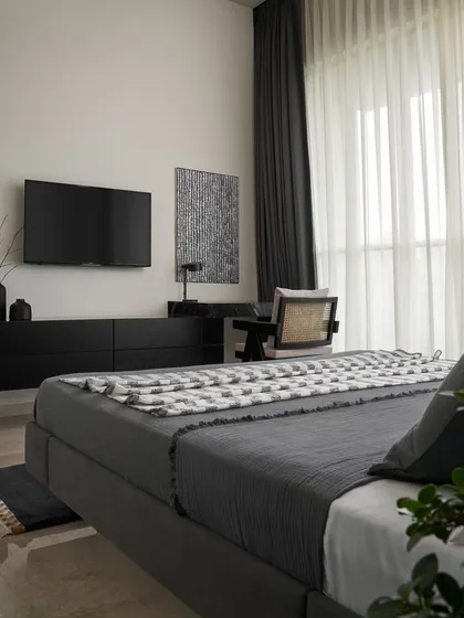 The Slate Bedroom is defined by its refined material selection. The custom floating bed enhances the sense of space, while the matte black glass drawers and Marquina marble desk create a cohesive and luxurious environment.