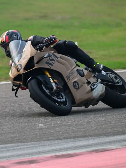 A rider on a custom-wrapped Ducati Panigale carves a turn at BIC, showing off both personal style and on-track skill.