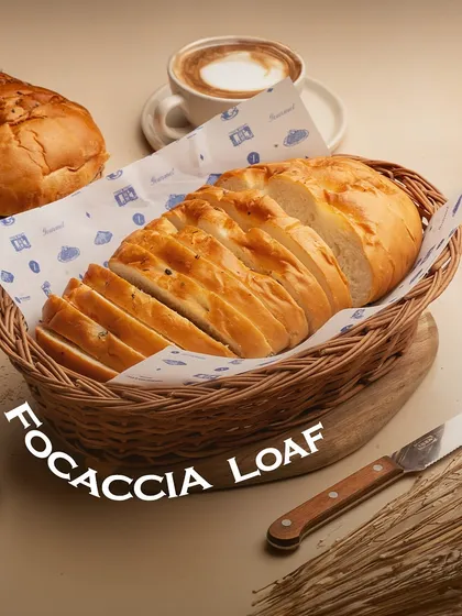 The Focaccia Loaf is an Italian classic. It's a soft, dimpled bread, infused with olive oil and herbs, perfect for dipping or as a base for sandwiches.