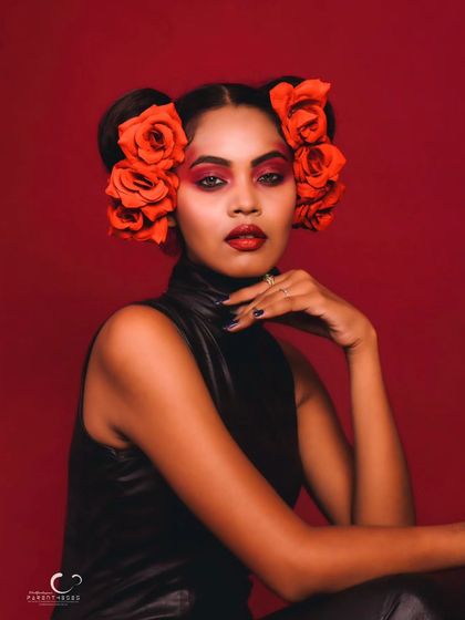 A direct and engaging close-up. Her expression is confident, and the artistic makeup makes this a standout beauty portrait.