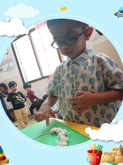 A child with glasses focuses intently on a phonics activity, demonstrating the engagement our programs foster. We ensure every child can participate and succeed.