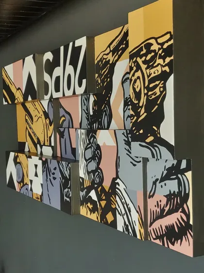 Another perspective on the finished Lounge29 artwork. The layered canvases and bold graphics make it a central feature of the lounge's interior design.