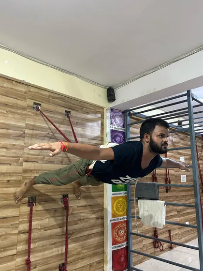 We use a variety of tools to challenge the body and build strength. This advanced asana, a variation of Viparita Shalabhasana (Superman Pose) using wall ropes, builds incredible core and back strength. It shows how we can use props to achieve poses that might otherwise seem impossible.