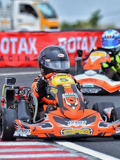 A driver navigates a tight corner during a heated race. Our championships are held on technical and challenging tracks to develop driver skill.