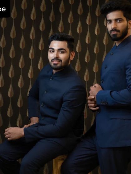 Two clients posing in matching navy blue bandhgala suits, a great option for groomsmen or family members.