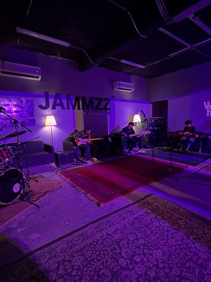 A band rehearsing in a jam room in Riyadh. This shows my commitment to exploring the entire music ecosystem in the cities I visit, from the main stage to the practice pad.