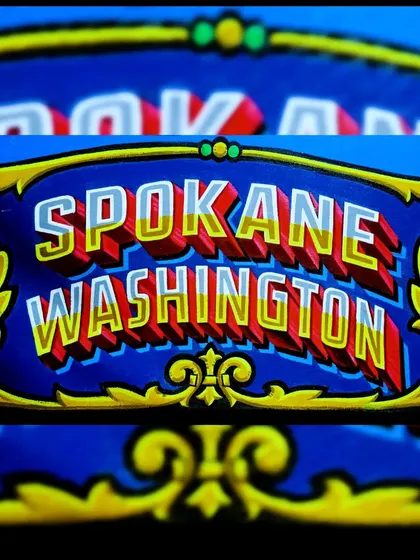 The "Spokane Washington" section of the Iron & Gold Tattoo sign, with its own unique color scheme.