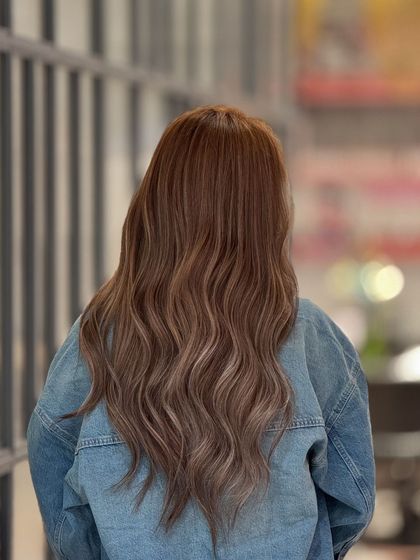 The back view of this ash blonde look, showing off the long, healthy hair and the beautiful blend of colors.