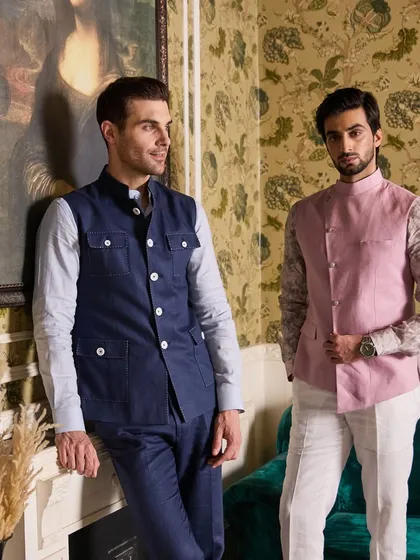 Layering is key to versatile style. Here, I showcase two distinct waistcoat designs from my Irish Linen collection. On the left, a rugged four-pocket hunting style in Azure Blue, and on the right, a modern asymmetrical cut in Pastel Pink, proving that a well-chosen jacket can define an entire outfit.