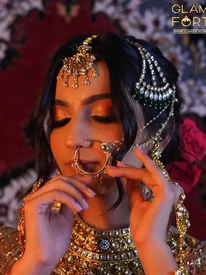 The rich colours and heavy jewellery of this look are balanced with warm, bronzed makeup. We teach how to manage and balance elaborate bridal styling.