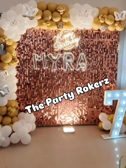 A wider view of the 7th birthday setup, showing how the balloon arch frames the sequin backdrop and marquee number, creating a complete and cohesive look.