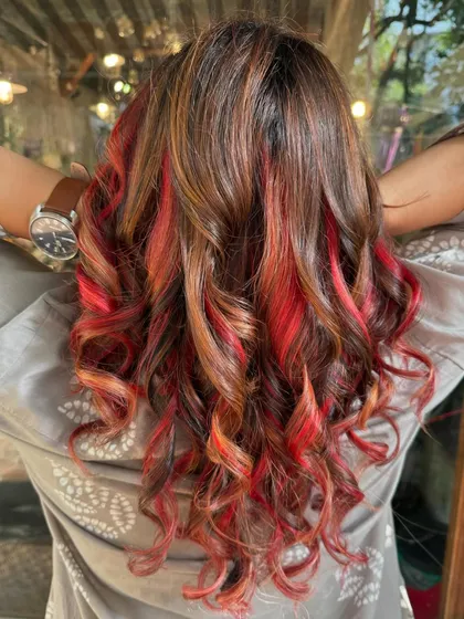 A peachy delight. This look is a mix of peachy pink and caramel tones, which required some bleach for the vivid peachy sections.