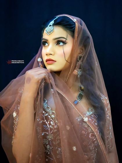 The sheer dupatta adds a touch of mystique. The makeup, especially the defined eyes, remains a captivating focal point.