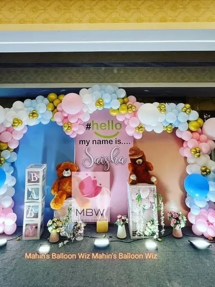 A full view of the naming ceremony stage, showing the personalized backdrop and adorable teddy bear props.