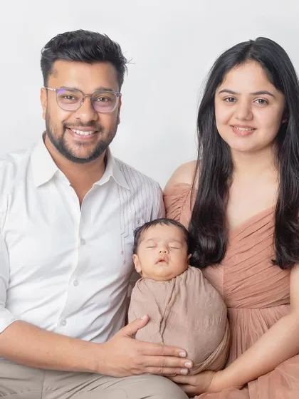 A classic seated family portrait with a newborn. The simple setup keeps the focus on the family's bond.
