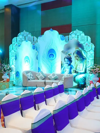 Celebrating a new life with a divine touch. For this baby shower, I designed a custom stage inspired by Lord Krishna, using peacock feather motifs and soft blue lighting to create a serene and blessed atmosphere for the family.
