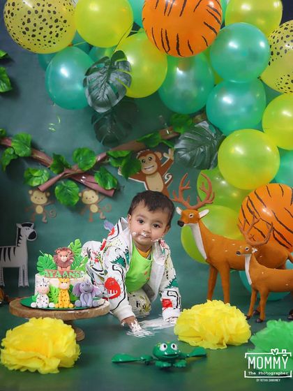 Digging into a jungle cake! This is what a successful cake smash looks like, full of fun, frosting, and unforgettable memories.