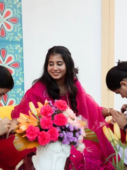 A candid moment of a guest enjoying the Mehendi application. We create a relaxed and festive atmosphere for everyone to enjoy the traditions.