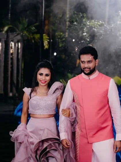 A beautiful shot of the bride and groom. Her custom mauve sangeet lehenga with its unique sculpted skirt makes a stunning statement.