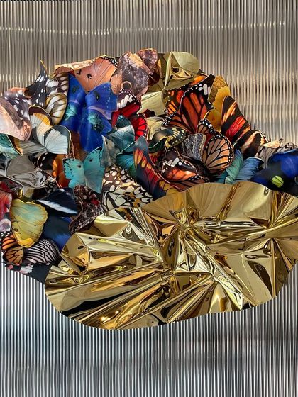 A frontal view of "Emphemeral Reflections," showcasing the beautiful contrast between the organic butterfly patterns and the abstract metallic form.